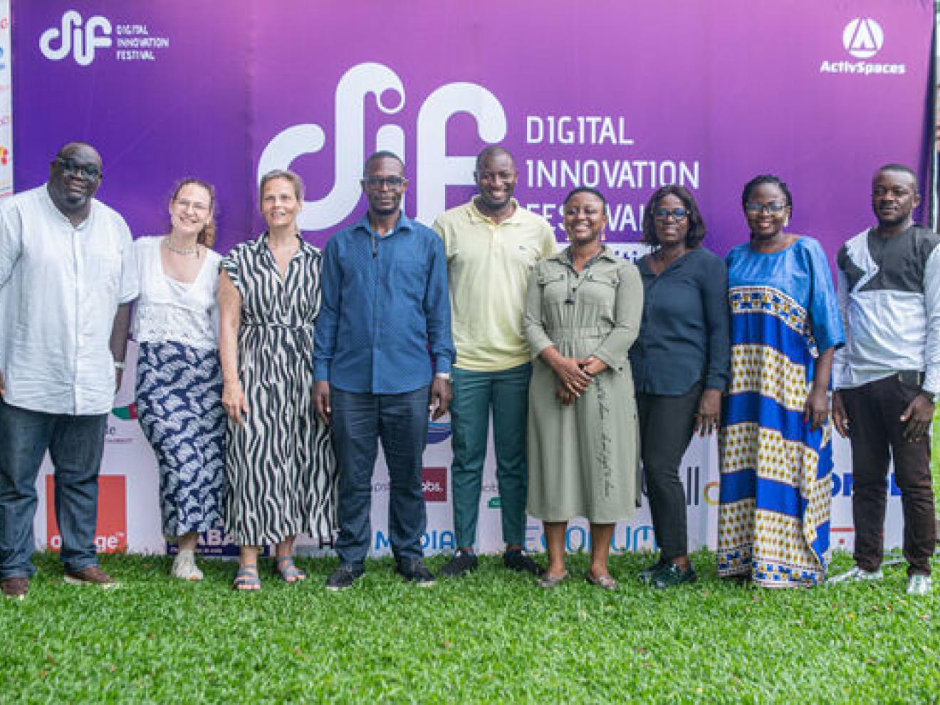 Gruppenbild vor einer Plakatwand im freien