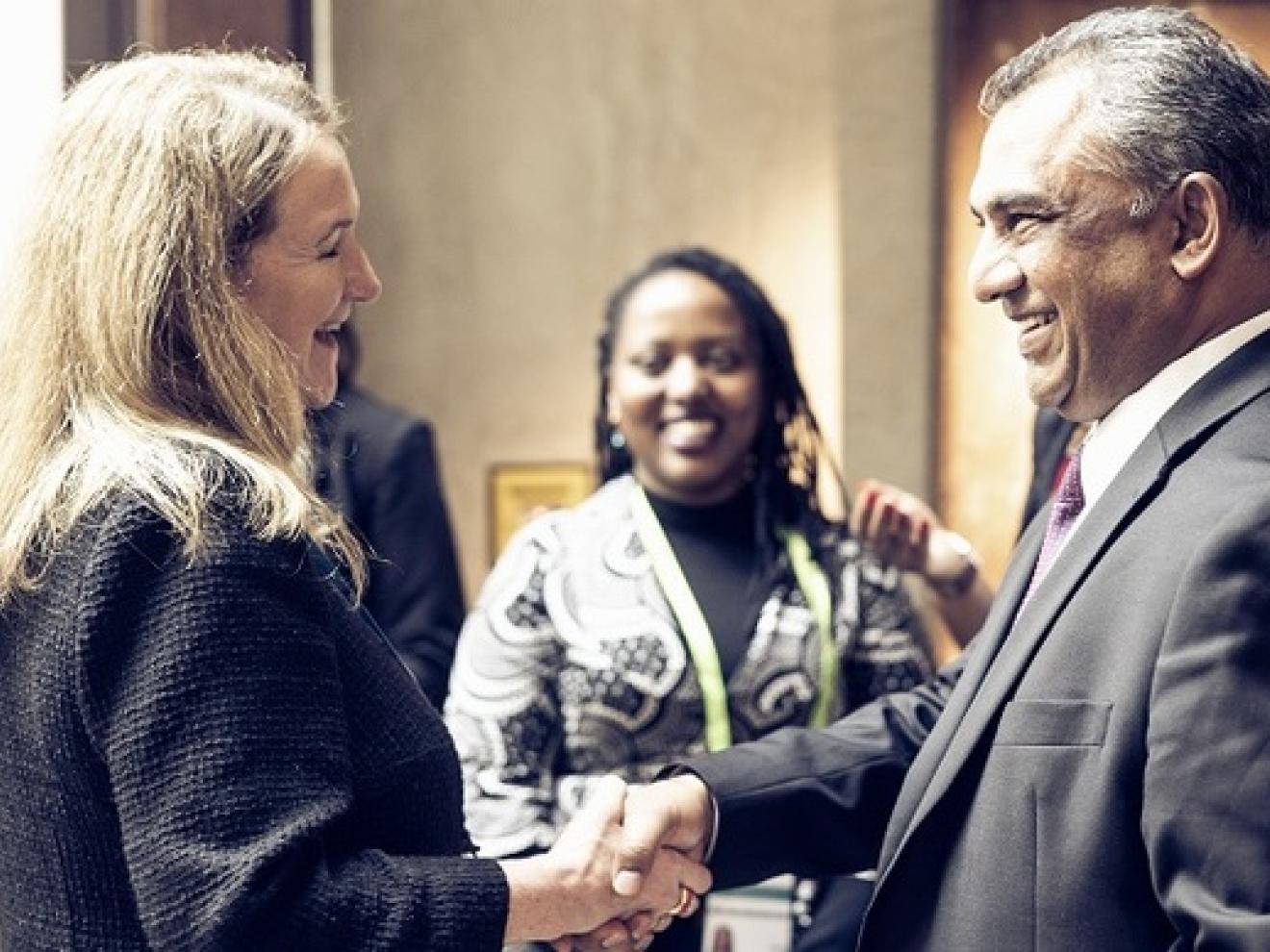 Ein Mann schüttelt einer Frau die Hand.