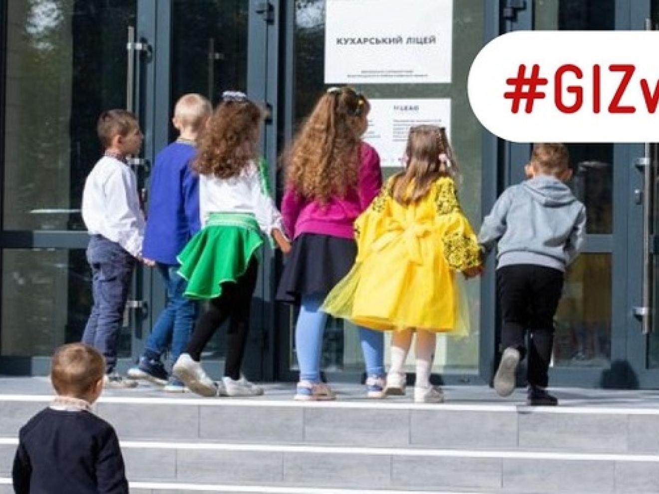 Children enter a reconstructed school in Ukraine.