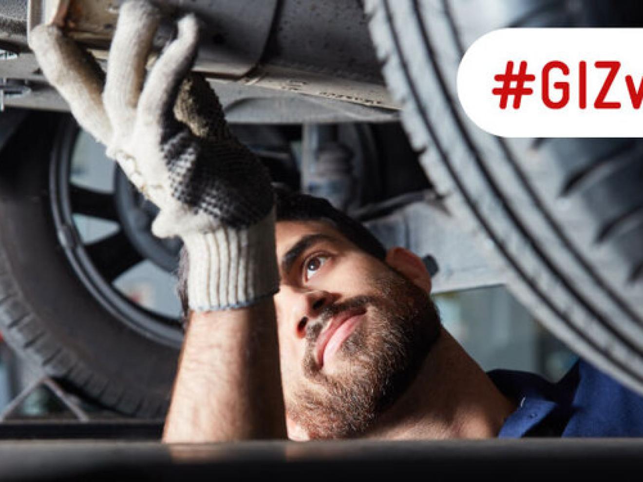 A vehicle mechanic repairing a car exhaust